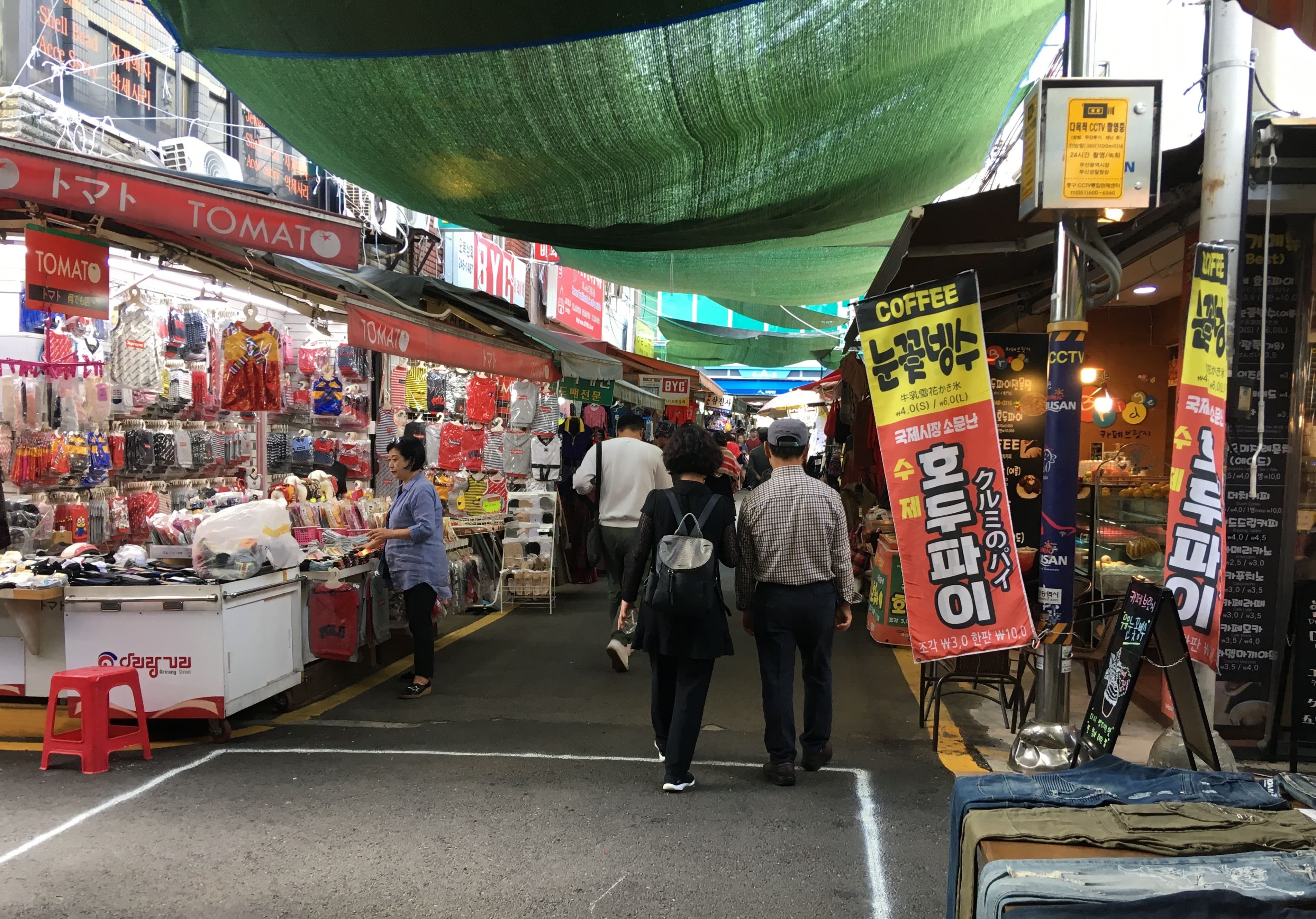 A shopfront-lined alley in Gukje Market, with the market's Korean signage visible