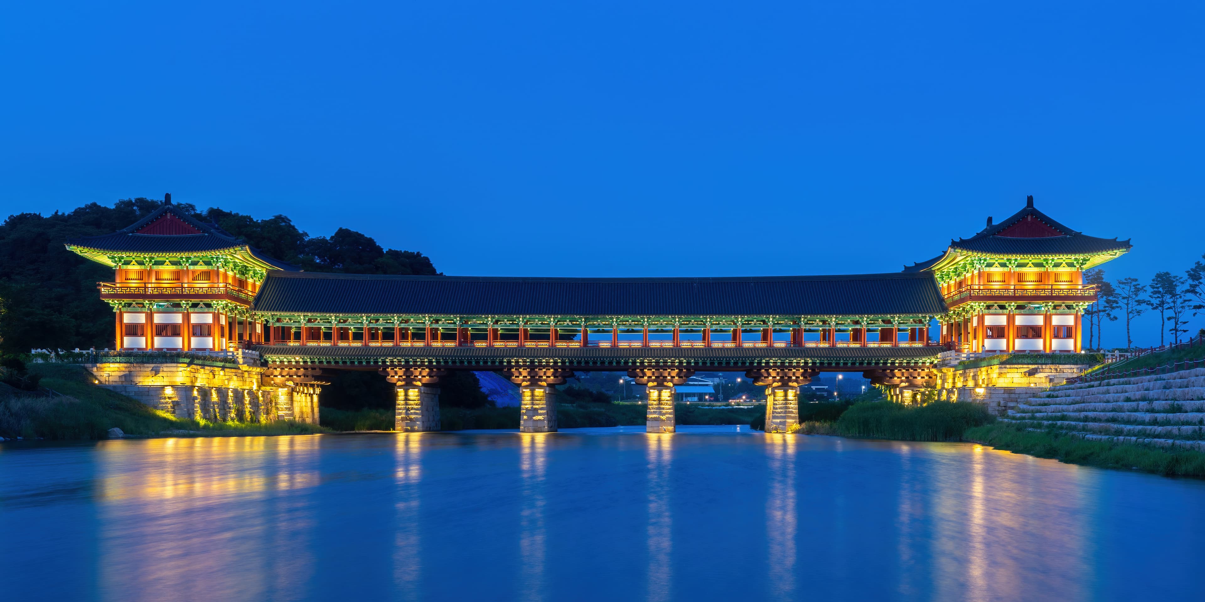 Woljeonggyo Bridge illuminated at blue hour, reflected in the river below