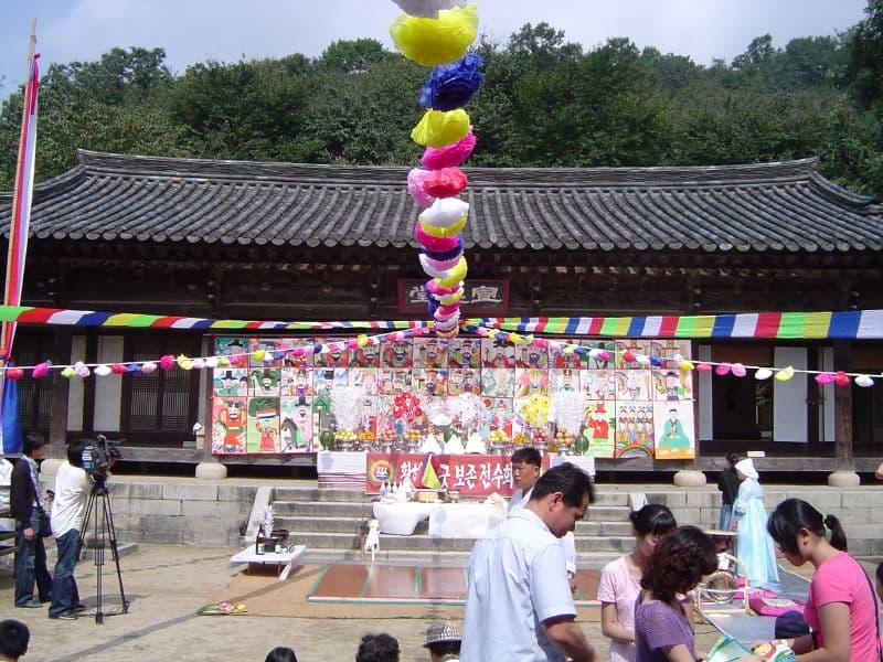 A traditional performance staged in front of a hanok building at the Korean Folk Village