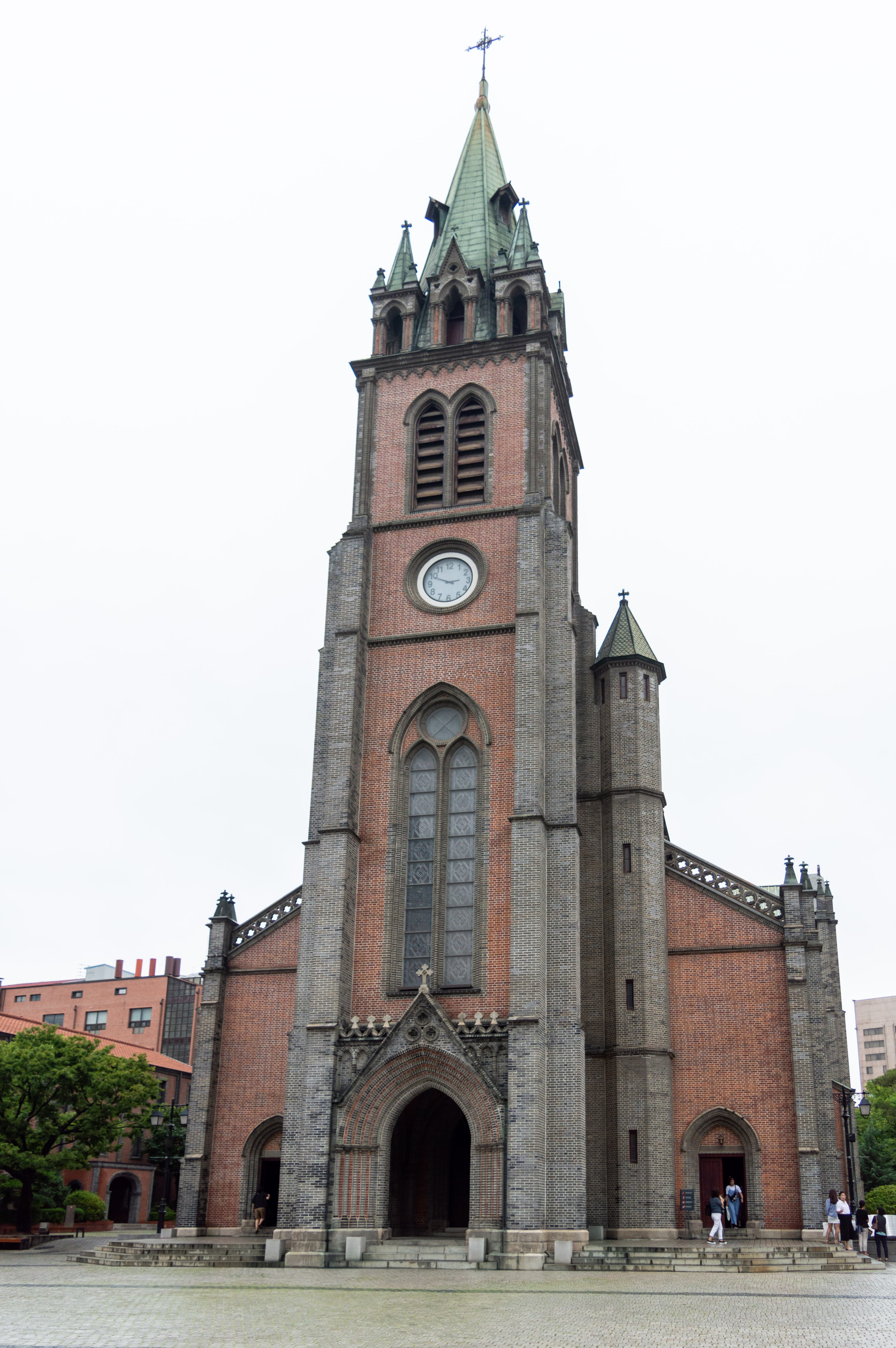 Front facade of Myeongdong Cathedral with its red-brick Gothic spire