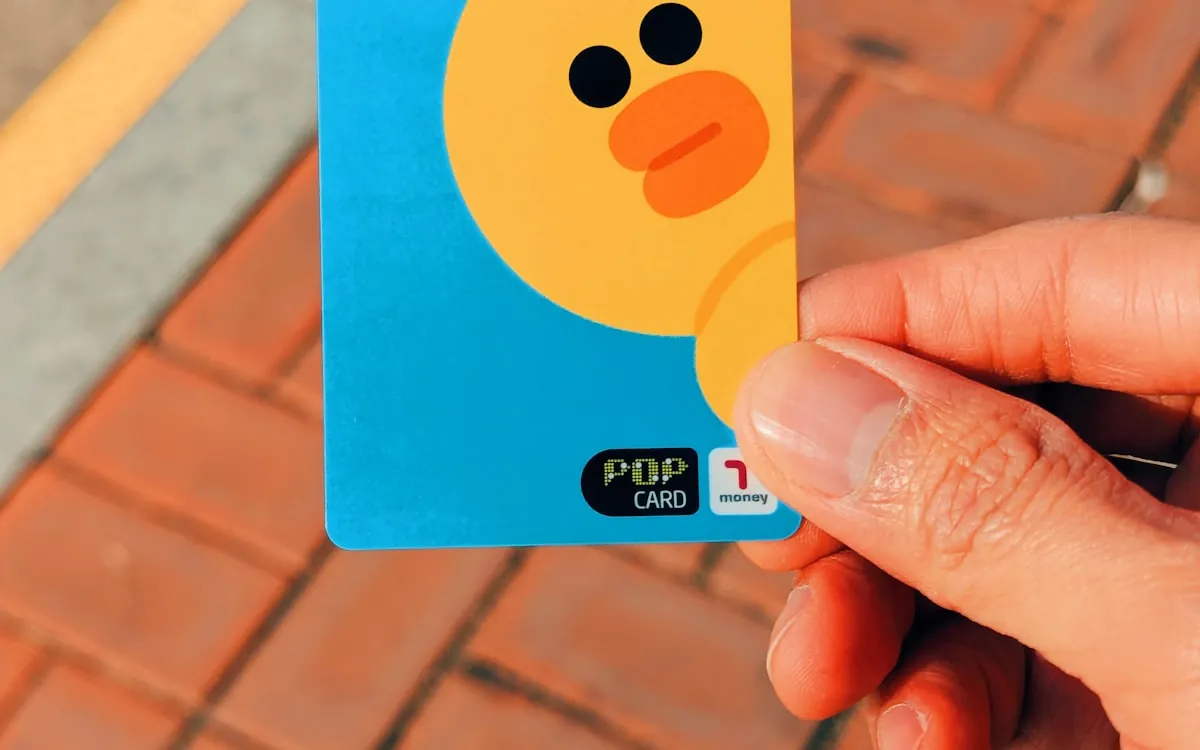 A hand holding a Line Friends character transit and payment card