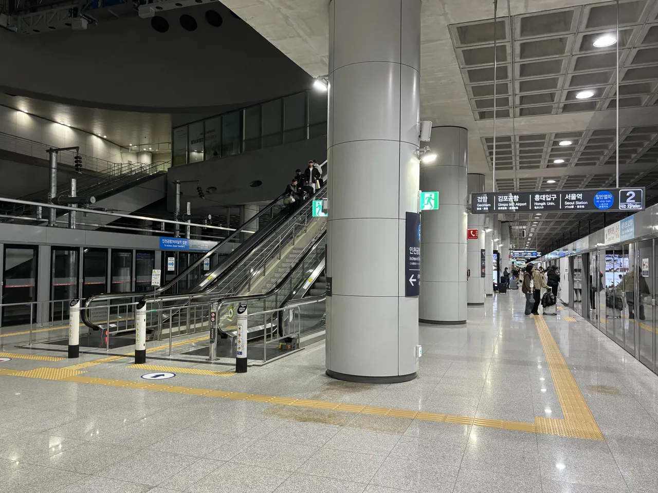 The AREX all-stop platform at Incheon Airport Terminal 1, its overhead board listing Geomam, Gimpo Int'l Airport, Hongik Univ. and Seoul Station in order