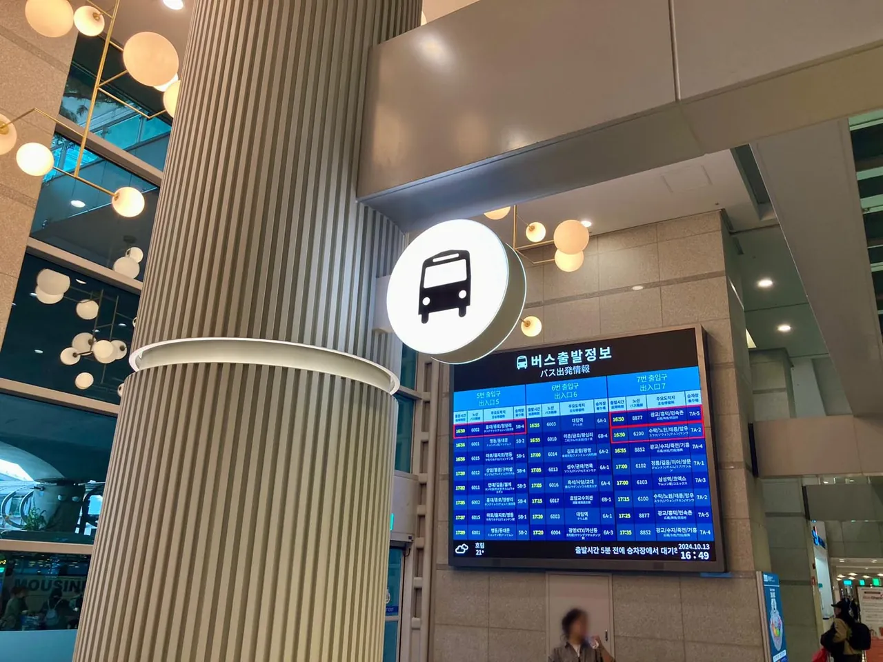 The bus departure board on the first floor of Incheon Airport Terminal 1, listing route numbers, departure times and stand numbers under each of exits 5, 6 and 7