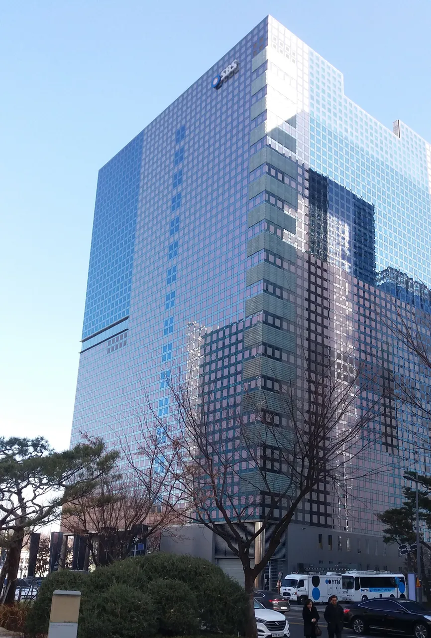 SBS Prism Tower in Sangam-dong: a glass-clad high-rise with the SBS logo near the top corner.